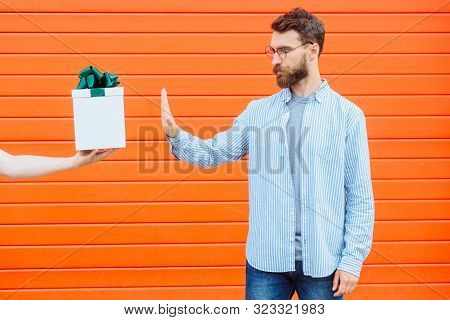 Hand Of Unrecognizable Person Holding And Giving Gift Box With Green Bow For Beard Hipster Man Isola