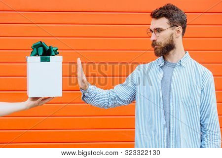 Hand Of Unrecognizable Person Holding And Giving Gift Box With Green Bow For Beard Hipster Man Isola