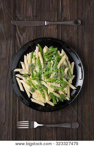 Penne Pasta With Green Beans And Cilantro On A Wooden Table. Tastier Served With Parmesan