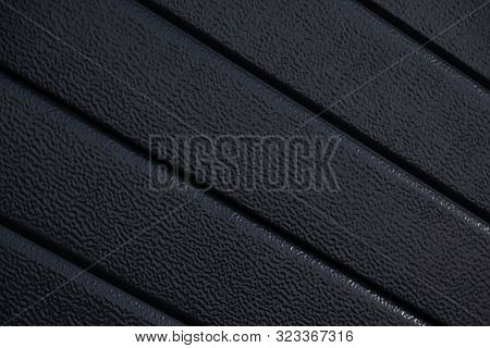 Diagonal Close-up Of Black Striped Corrugated Surface With Scaliness Defocused