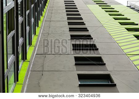 Bottom View Of High House Building With Long Row Of Windows