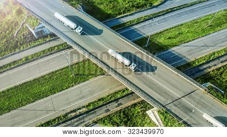 Gasoline Fuel Trucks Caravan Driving By The Highway Road. Top View From Drone.