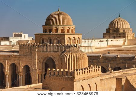 Minarets Of The Sidi Ukba Mosque In Kairouan, Tunisia, Africa Against The Sky On A Sunny Day