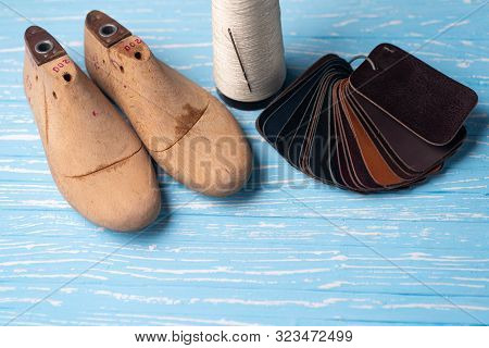 Leather Samples For Shoes And Wooden Shoe Last On Blue Wooden Table. Designer Furniture Clothes. Sho