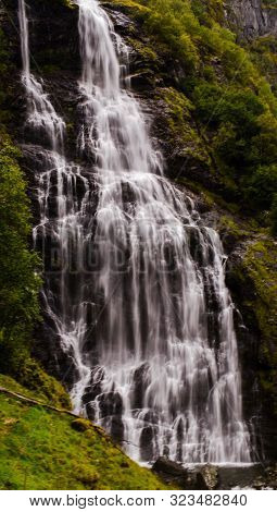 Waterfall Flowing In Fjord Region Of Norway.