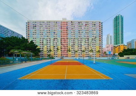 Colorful Rainbow Pastel Building With Basketball Court And Facade Windows Background In Public Park.