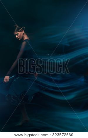 Beautiful girl performs Latino dance with expression. Professional dancer in motion. Beauty, fashion.