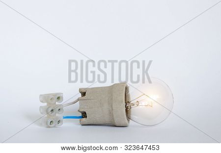 Lighting Incandescent Lamp Bulb With Cap, Socket, Wires And Terminal Block Lies On White Background,