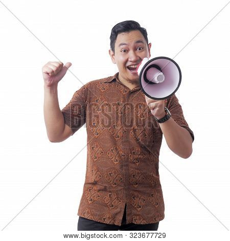 Young Asian Businessman Wearing Batik Using Megaphone, Promoting Gesture. Close Up Body Portrait. Is