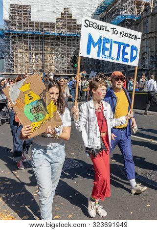 London / Uk - September 20th 2019 - Young Climate Change Activist Hold Signs Saying Sequel To Frozen