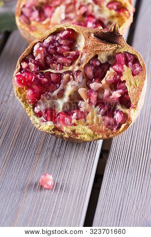 Half Pomegranate Over A Table