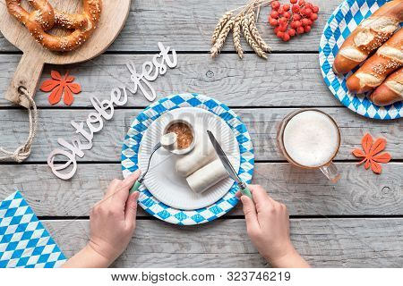 Oktoberfest Traditional Food And Beer. Hands Of The Woman Eating White Sausage. Pretzels And Bread S