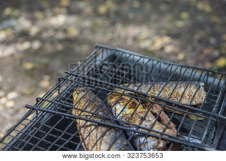 Food Concepts. Closeup Of Spiced Mullet Seafood Preparing On Grill. Horizontal Orientation