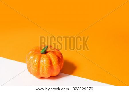 Autumn Composition, Halloween Concept. Pumpkin On Orange Background. Empty Space For Your Text.