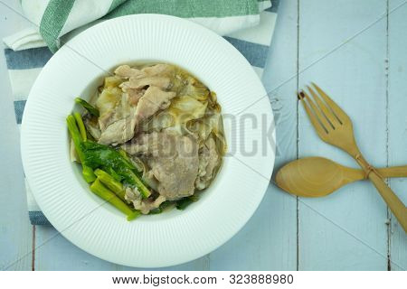 Rice Noodles With Marinated Pork And Chinese Kale In Gravy