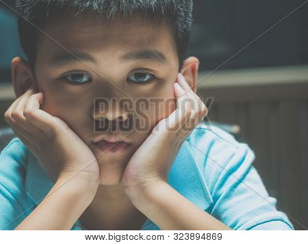 Sad Lonely Boy, Young Homeless Asian Child High Risk Of Being Depressed, Bullied And Abused. Miserab