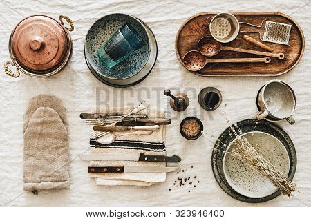 Various Kitchen Utensils And Tablewear Over Rustic Linen Tablecloth