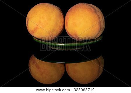 Group Of Two Whole Fresh Fuzzy Peach On Green Plate Isolated On Black Glass