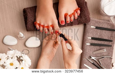 Master Makes A Beautiful Pedicure In The Beauty Salon