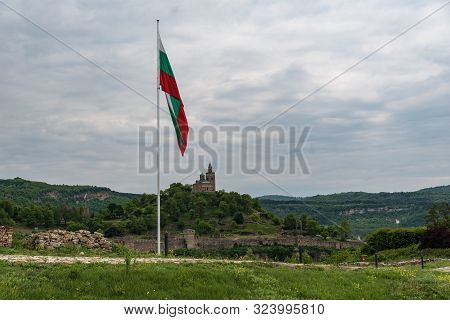 National Bulgarian Flag In Trapezitsa Fortress  With   Tsarevets Fortress At Background. Veliko Tarn