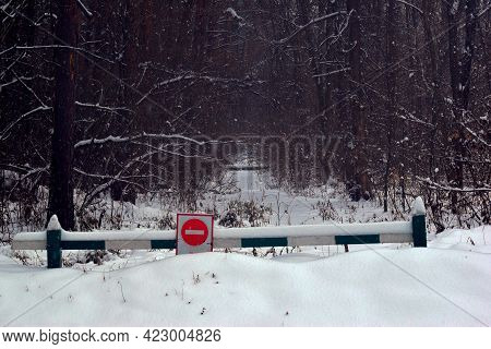 Prohibition Sign And Barrier In Winter Forest. Sign Entry Is Prohibited On The Background Of A Snowy