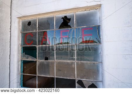 Old Abandoned Cafe Sign On A Broken, Busted Window, In The Glenrio, Texas Ghost Town Along Route 66