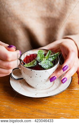 woman eating berry desset in cafe