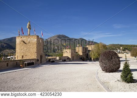 Caravaca, Murcia Province, Spain - November 17, 2017: Fortress Wall With Towers And A Stone Cross, A