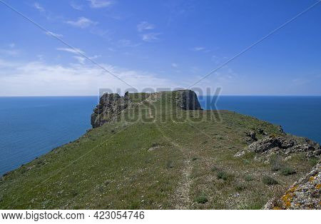 Steep Rocky Cliff Above The Sea. Cape Meganom, Crimea. Sunny Day At The End Of Apri