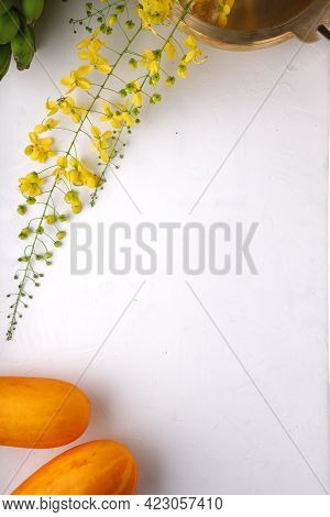 Golden Shower Flower,yellow Cucumber And Raw Banana Bunch Arranged On A White Surface With Grey Text