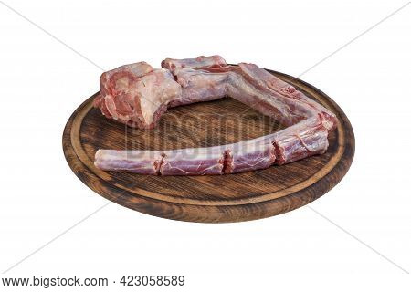 Whole Fresh Raw Beef Tail Chopped Into Pieces On Round Wooden Board Isolated On White Background.