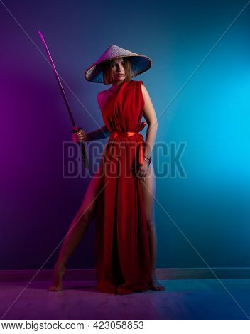 Sexy Woman In A Red Cape And An Asian Hat With A Katana In Her Hand Image Of A Samurai In Neon Color