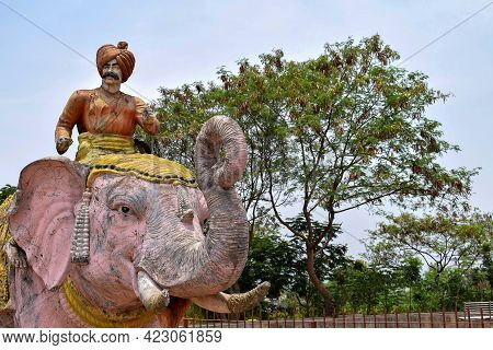 Stock Photo Of Middle Aged Indian Warrior Statue, Wearing Orange Color Turban And Traditional Cloth 