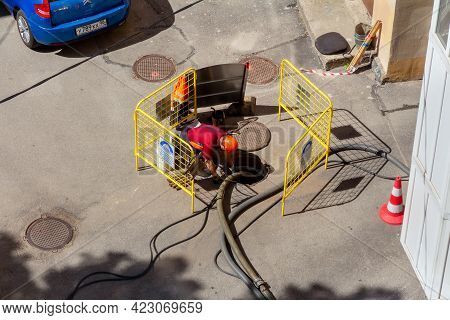 Saint Petersburg, Russia - June 08, 2021: A Worker During Work On The Repair Of Water And Sewer Pipe