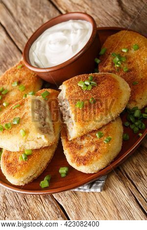 Potato Zrazy With Meat Served With Sour Cream Close-up In A Plate On The Table. Vertical