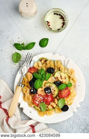 Pasta Fiocchi Salad With Vegetables Grilled Zucchini, Cherry Tomato, Olives, Basil And Parmesan Chee