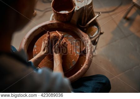 Professional Ceramicist Working With Fresh Wet Clay In Pottery Workshop
