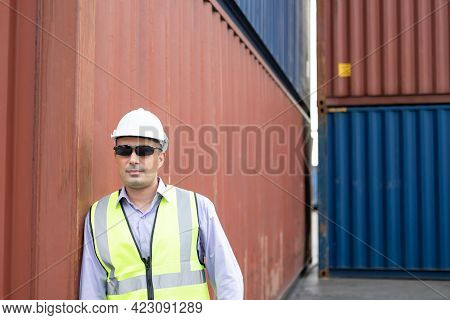Caucasian Men Freight  Supervisor Wearing Safety Vest And Hat While Inspect Condition Of All Contain