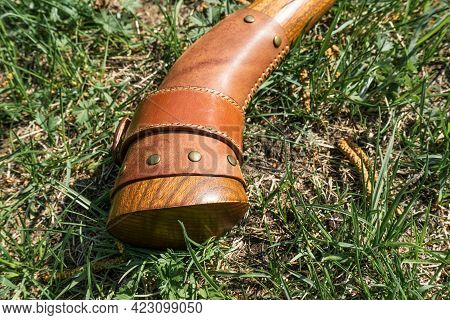 The Battle Ax Is On The Ground Next To A Large Stone. Forged Ax