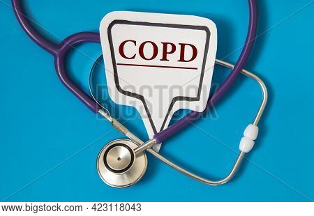 Copd - Acronym On White Figure Sheet On A Blue Background With A Stethoscope. Medical Concept