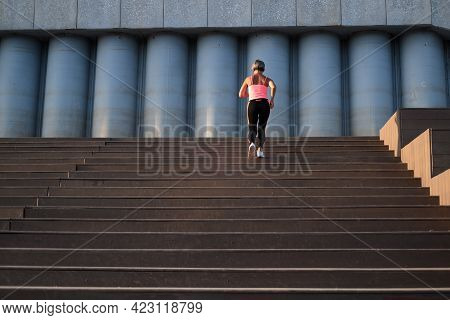 Active Seniors Woman Running On Stairs In The City