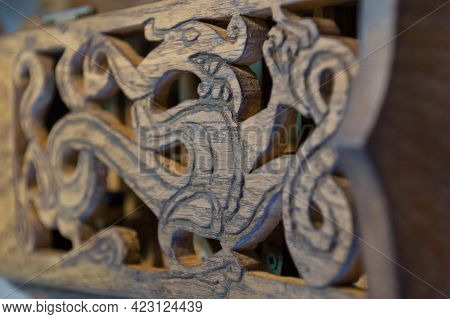 An Image Of A Dragon Carved From Wood - An Ancient Novgorod Ornament - On The Lid Of A Hand-made Fol