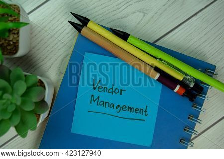 Vendor Management Write On Sticky Notes Isolated On Wooden Table.