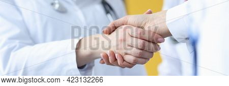 Closeup Of Doctor And Patient Handshake In Clinic
