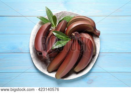 Tasty Red Baby Bananas On Light Blue Wooden Table, Top View