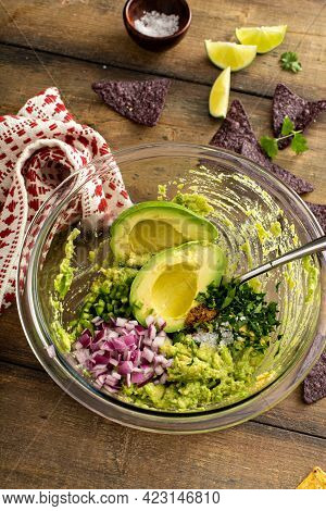 Making Guacamole With Red Onion, Jalapeno And Cilantro