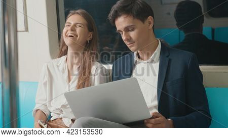 Young Caucasian White Business Woman And Man Sitting Using Laptop Computer Working Talking Together 