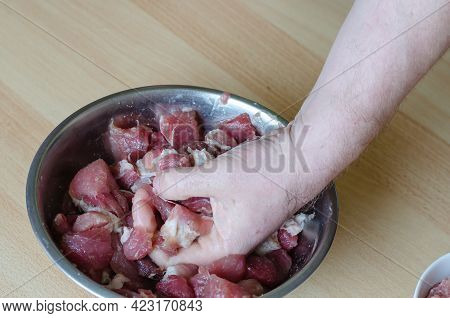 Step By Step Preparation Of Homemade Chopped Ham. Step 7: A Hand Mixes Minced Meat And Chunks Of Mea