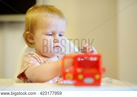 Cute Baby Girl Playing With Bright Toy. Toddler Having Fun With Eco Educational Toys. Game And Enter