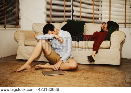 The Husband Sat Down Worried By His Wife On The Sofa : Unhappy Couple, A Family Having Split, Relati